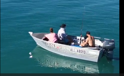Three people fishing from the "All Abord" tinny boat on calm, turquoise waters in Shark Bay. Monkey Mia Boat Hire Shark Bay vessel.